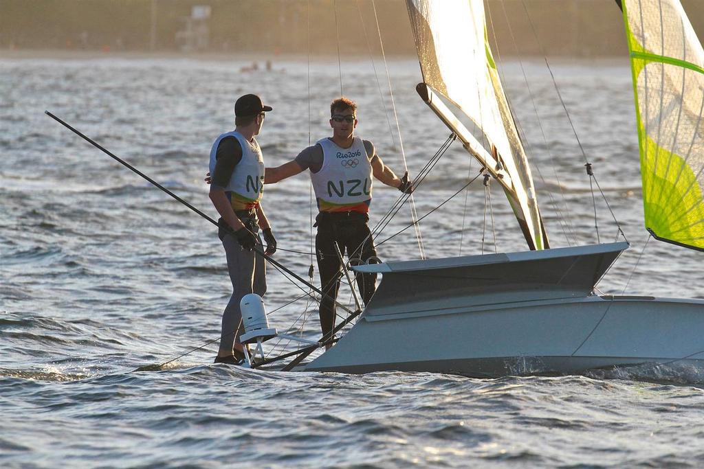 Blair Tuke discreetly congratulates skipper Peter Burling (NZL) after their second win from two races on the opening day of the Mens 49er - Rio Olympics © Richard Gladwell www.photosport.co.nz